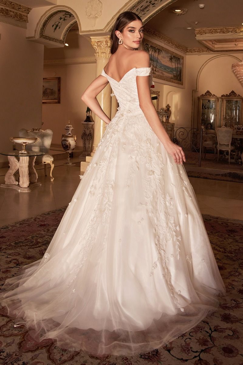 Peony White Gown is a layered tulle ball gown with floral diamond glitter motif trickling down the gown. 3D organza flowers add couture depth to the garment, while the off-white tone of the dress softly blends into the shimmering embellishment. The bodice features a off shoulder bodice that is fully lined mid back for bra coverage. The skirt is A-line shape with crinoline to support the silhouette.