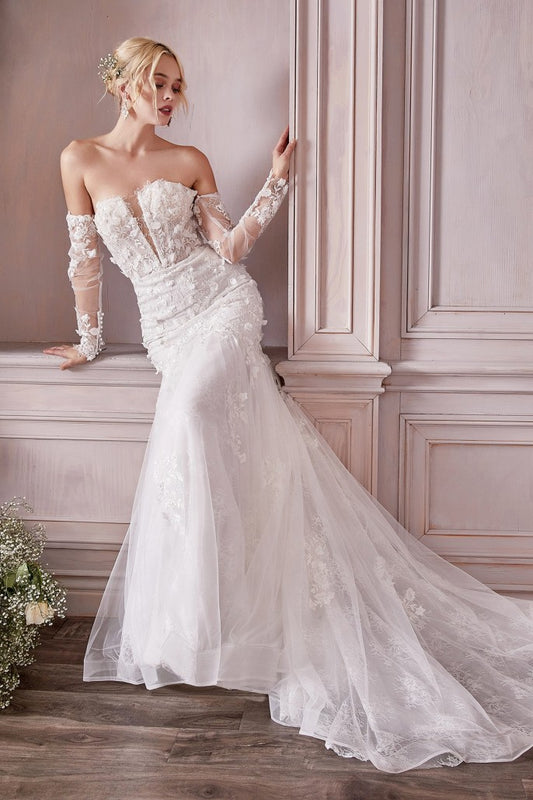 Prepare to meet the bridal gown of your dreams. This breathtaking strapless mermaid gown is cut from a delicate chantilly lace and layered with flowing tulle adorned with three dimensional floral appliques. The fitted bust is designed with a plunging v-neckline and lace up corset back for a custom fit. Off the shoulder long lace sleeves are detachable at the underarm for a transitional look.