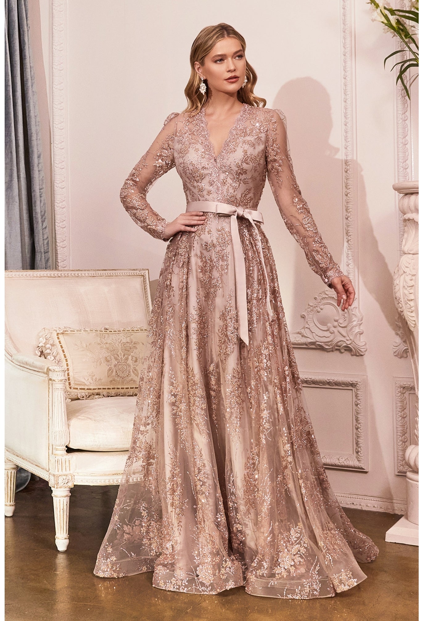 Look unforgettable in this embellished long sleeve dress with A-line skirt. Long Sleeve Embellished Ball Gown V-neck bodice with long sleeves Enclosed sheer back with zipper closure Floor length A-line skirt with sweep train Details: Bra Cup, Fully Lined Fit: The model is 5'8" and is wearing 4" heels