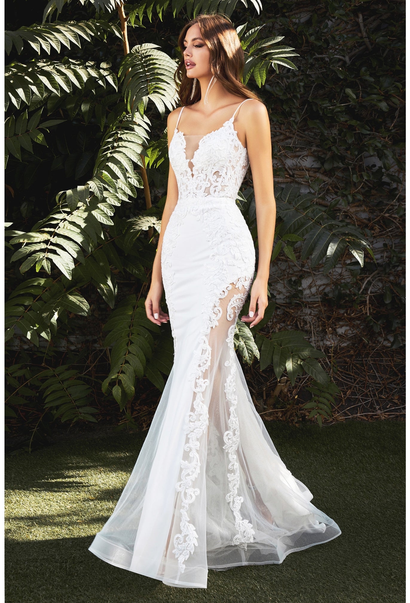 This gorgeous mermaid gown features a corseted sheer tulle bodice with an embroidered lace appliqué that trails down the body and frames the fluted skirt. A tulle overlay reveals a thigh-baring cutaway at the skirt’s underpinning, serving a noteworthy alternative to a classic bridal look. The bodice’s plunging v-neckline has an illusion mesh insert edged with hand-cut lace. Delicate straps turn to reveal an alluring back bodice design and flattering basque waistline.