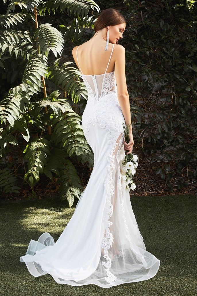 This gorgeous mermaid gown features a corseted sheer tulle bodice with an embroidered lace appliqué that trails down the body and frames the fluted skirt. A tulle overlay reveals a thigh-baring cutaway at the skirt’s underpinning, serving a noteworthy alternative to a classic bridal look. The bodice’s plunging v-neckline has an illusion mesh insert edged with hand-cut lace. Delicate straps turn to reveal an alluring back bodice design and flattering basque waistline.