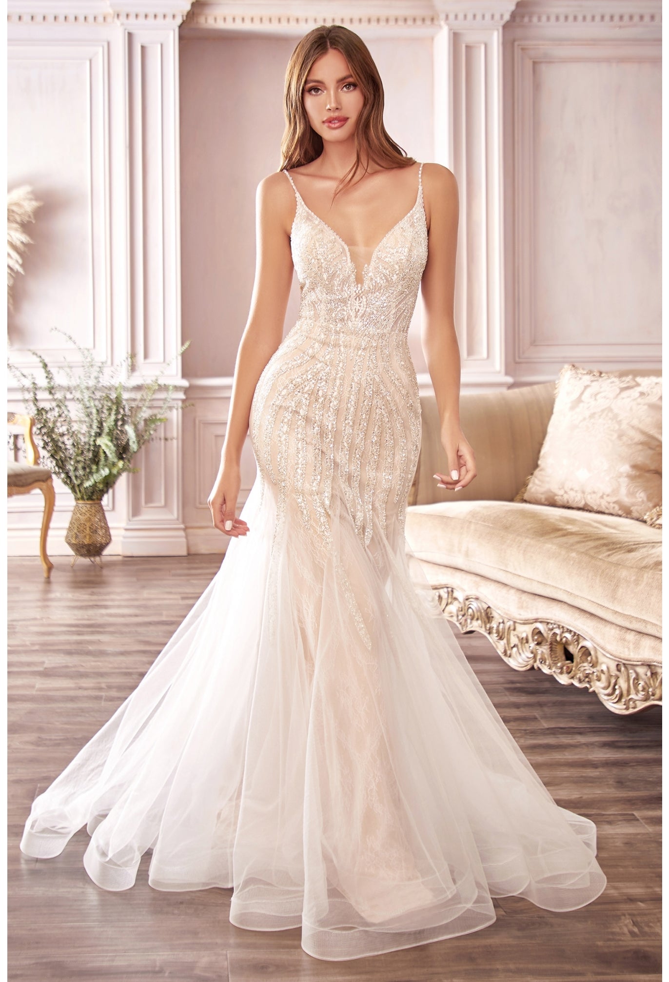 This impeccably crafted gown will accentuate your hourglass shape with a dramatic floor-sweeping mermaid skirt. Sheer layered tulle and chantilly lace is embellished with beading that shimmers as you move. The dress features a deep illusion v-neckline that turns to reveal a low open back, delicately suspended by beaded spaghetti straps. The dress is lined with stretch lining for the wearer's comfort.