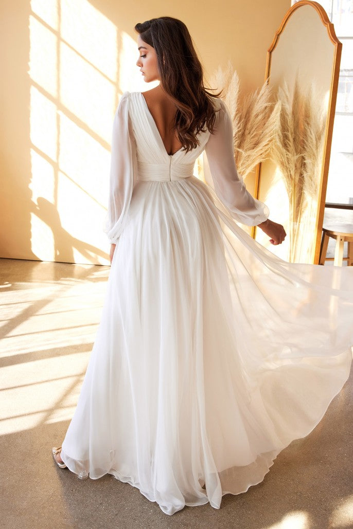 This dreamy chiffon gown features a layered a-line skirt gathered at the waist. Sheer long sleeves drape the arms up to the gathered deep v-neckline bodice and ruched waistband. The back has a mid-opening allowing for bra strap coverage.