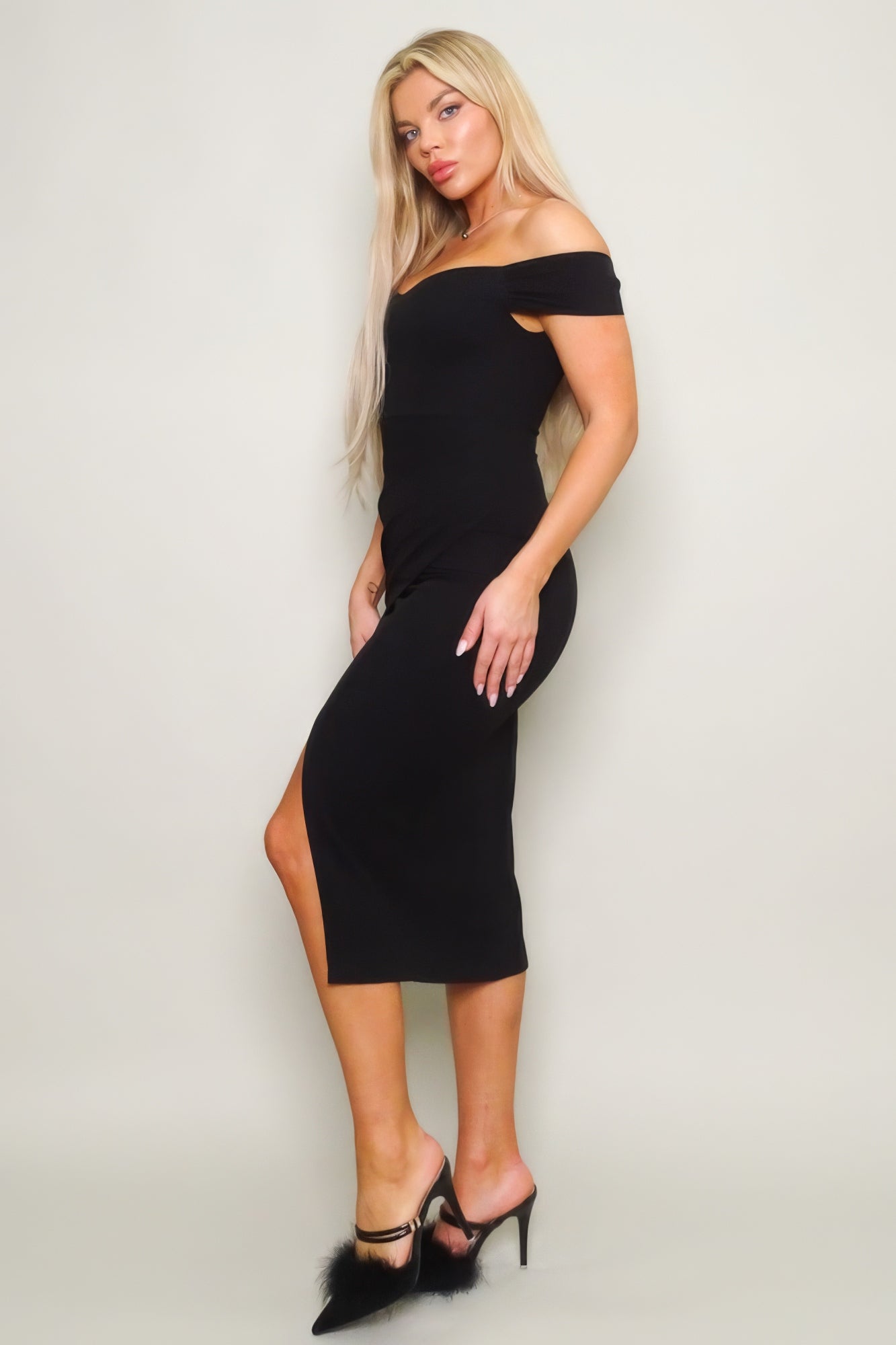 Introducing our Off Shoulder Techno Crepe Midi Dress in the delicate hue of Black a graceful and chic ensemble tailored to enhance your elegance. Meticulously crafted with attention to detail, this dress seamlessly blends sophistication with comfort.