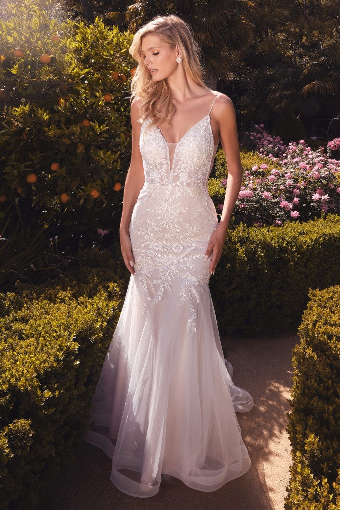 The Vika is a beautifully crafted mermaid gown featuring an ivy embroidered lace with glass beads that trails down the body and frames the mermaid skirt. A removable tulle ribbon is a precious detail on the beaded spaghetti strap. The bodice’s plunging v-neckline has an illusion mesh insert edged handsewn beading as well as the side bodice. The gown turns to reveal a translucent back bodice design and slimming basque waist