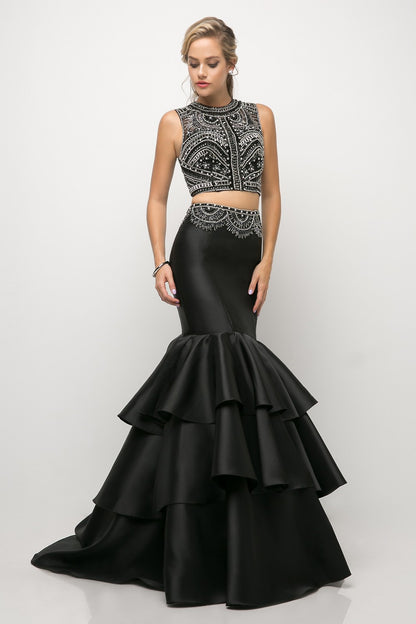 Captivate the room in this beaded two piece crop top mermaid dress with ruffled skirt.  Sleeveless beaded bodice 2 Piece Mermaid Gown High neck illusion Floor length tiered trumpet skirt Sweep train Open back cutout Details: Bra Cup, Fully Lined
