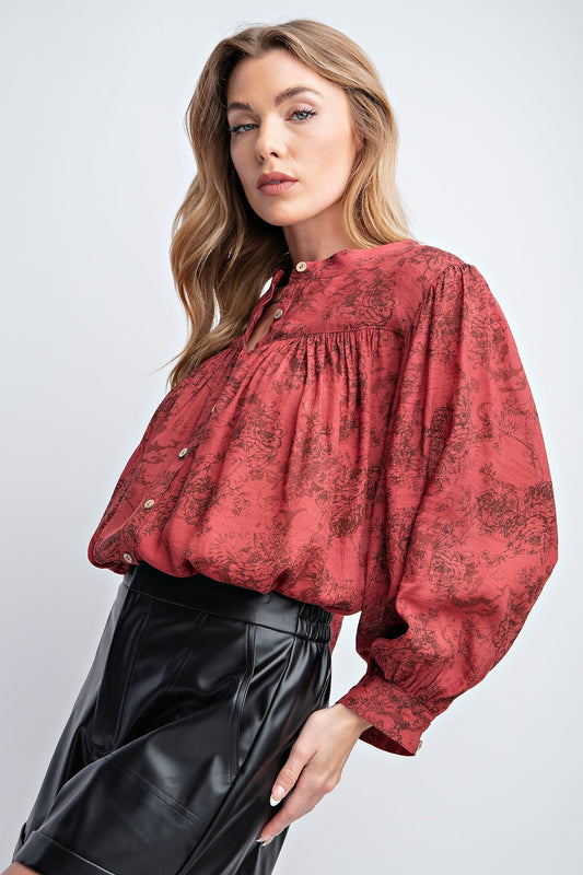 Relaxed fit smock style top with 3/4 sleeves and rounded hem. Featured with floral print, bishop sleeves, crepe button down front and cliffs. Material: 65% Rayon 35% Polyester.