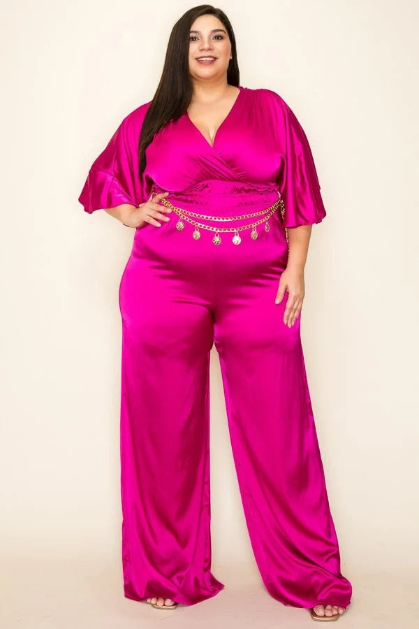 Magenta color. Satin wrap front short sleeve smocked waist jumpsuit with chain belt.                              97% Polyester 3 % Spandex 