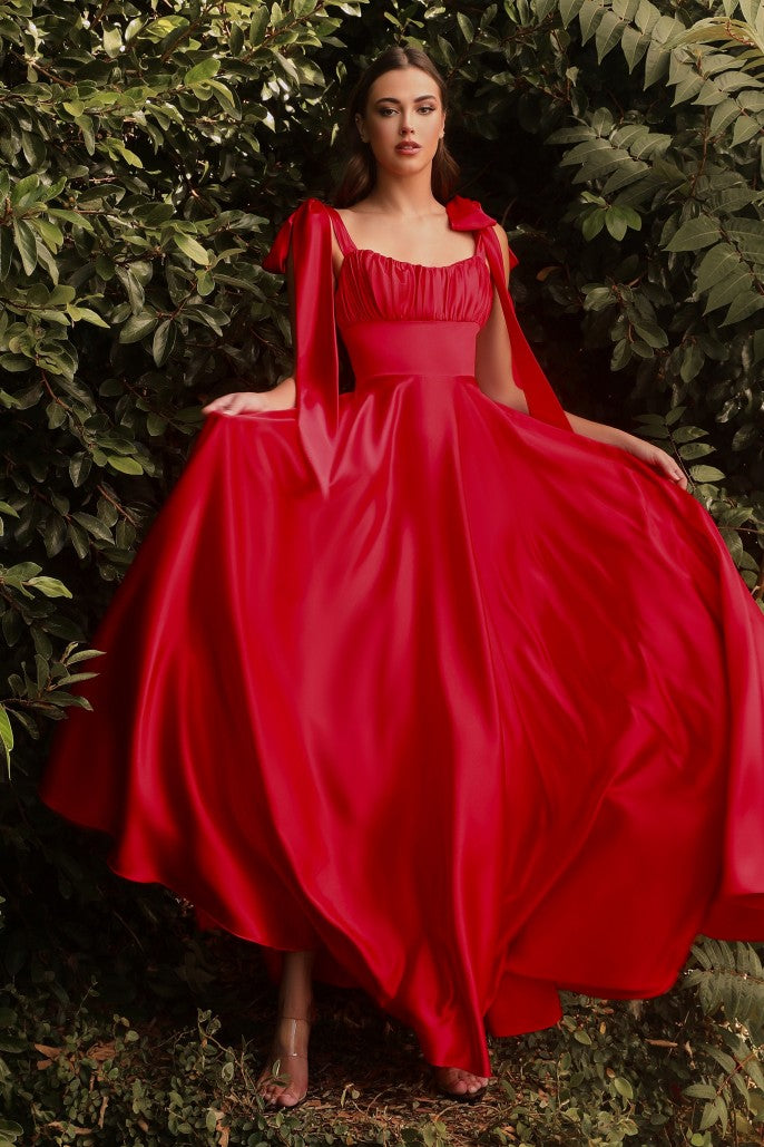 Cut from a soft flowing satin this floor length dress is the perfect fit for multiple occasions. This A-line shape has a banded empire waist and gathered sweetheart neckline. Tying satin straps allow for a custom fit and shoulder bow detail.