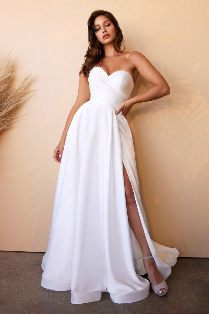 This dreamy satin bridal ball gown is the complete chic look. Simple sophistication is effortlessly achievable with this strapless pleated sweetheart neckline. The leg slit can be worn open for a sultry look or tacked down for the more modest bride. Lines that are hem for ripping volume and satin covered buttons adorn the center back zipper.
