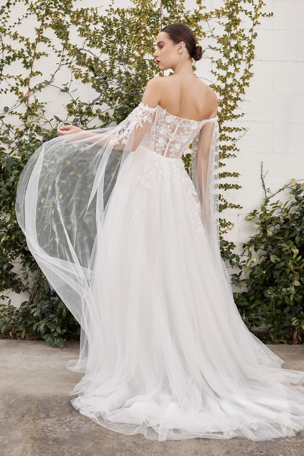 This diaphanous gown features a sheer strapless bodice and frothy A-line skirt cut from layers of soft tulle to a floor-sweeping hem. The bodice has supportive internal boning to ensure it stays in place and is framed by elongated tulle sleeves split along the inseam, falling to meet the hem of the skirt and conjuring up an ethereal mood. Hand cut degrade lace placements flower about with pearlescent beaded accents.