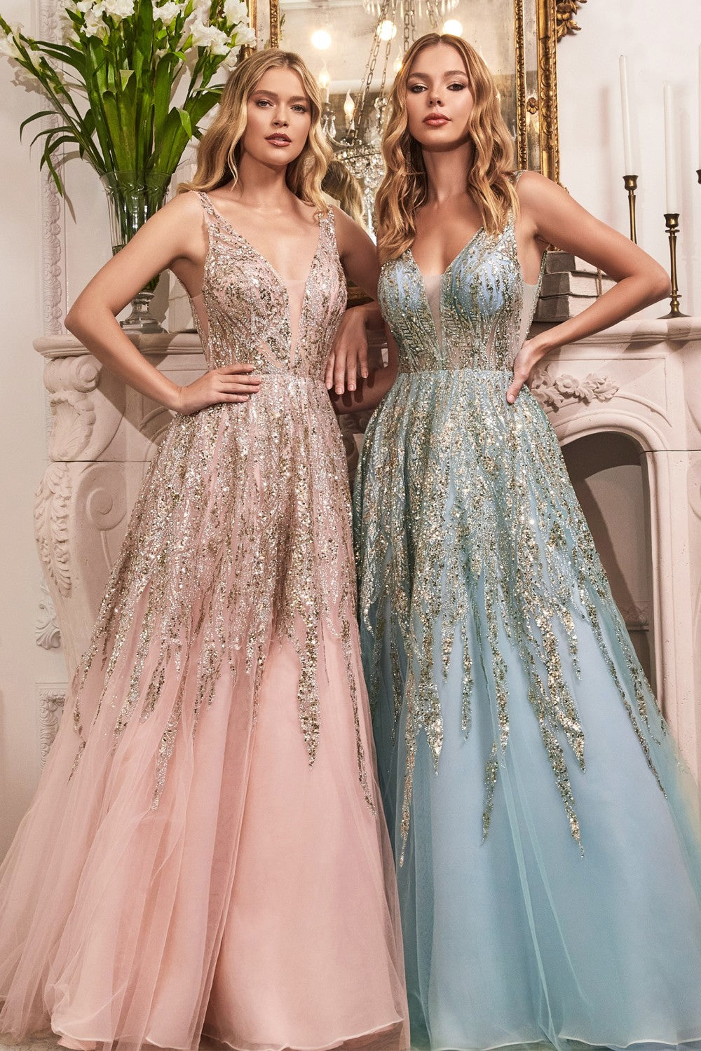 Dance the night away in this layered tulle ball gown. Shimmering glitter and bead embellishment adorn this gown from bodice to skirt. Styled with a deep plunging neckline, open back and illusion cut out sides.