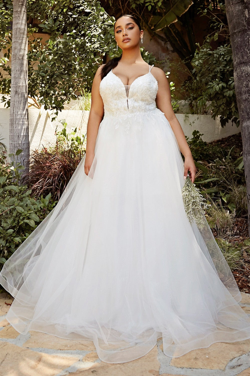 Breathtaking, sleeveless off white A-line gown with a beaded V-neck bodice and payed tulle skirt.   A-line gown Beaded appliqué bodice Layered tulle skirt Sleeveless, spaghetti strap bodice Illusion V-neckline Open back Bra cup, fully lined