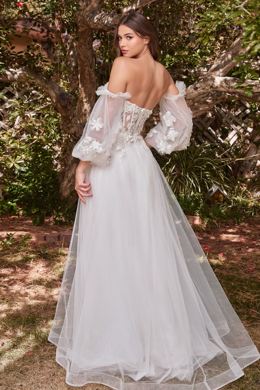 Cut from layers of tulle, this princess gown features a sheer tulle corseted bodice, detachable off-the-shoulder blouson sleeves, and a lightly gathered skirt with flowing proportions. The bodice is strategically embellished at the bust, waist and sleeves blooming with floral appliques. Its strapless sweetheart neckline is softened with a lace applique edge.